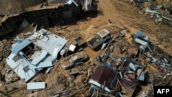 This aerial photo shows collapsed buildings in the aftermath of flooding in Meizhou, in southern China's Guangdong province, June 21, 2024. Heavy rains have triggered deadly landslides elsewhere in the country, including one in Hunan province where a landslide killed eight.