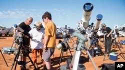 People prepare their viewing equipment in Exmouth, Australia, ahead of a solar eclipse, April 20, 2023.
