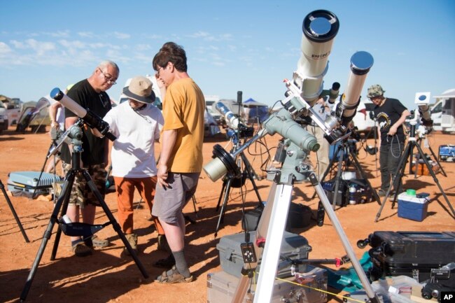 FILE - People prepare their viewing equipment in Exmouth, Australia, ahead of a solar eclipse, April 20, 2023. (Aaron Bunch/AAP Image via AP)