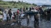 (FILE) War-displaced people, local residents and a Congolese soldier set off for Goma on a handmade wooden boat in the Democratic Republic of Congo, on March 10, 2024.