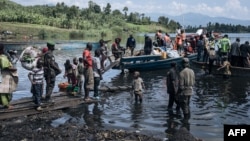 (FILE) War-displaced people, local residents and a Congolese soldier set off for Goma on a handmade wooden boat in the Democratic Republic of Congo, on March 10, 2024.