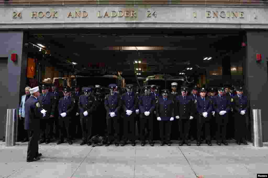 Firefighters from Hook and Ladder 24 Engine 1 fire station observe a moment of silence on the day of the 22nd anniversary of the September 11, 2001 attacks on the World Trade Center, in New York City.
