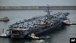 The USS Theodore Roosevelt (CVN 71), a nuclear-powered aircraft carrier, is anchored in Busan, South Korea, June 22, 2024. 