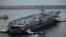 The USS Theodore Roosevelt (CVN 71), a nuclear-powered aircraft carrier, is anchored in Busan, South Korea, June 22, 2024. 