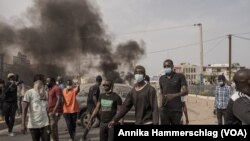 Protesters pushed parked cars onto streets to be used as roadblocks in Dakar, Senegal, March 16, 2023.