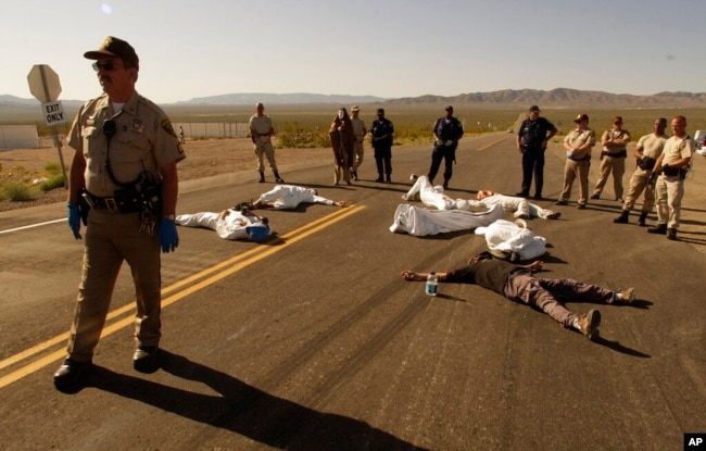 FILE - Protesters opposed to a nuclear storage facility and weapons testing lie down at the Nevada Test Site at Mercury, Nevada, May 11, 2003. Advocates have long been trying to bring awareness to the lingering effects of nuclear fallout.