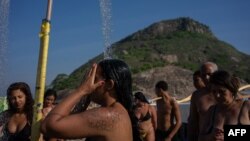 Sunbathers cool off at Macumba Beach in Rio de Janeiro on Sept. 24, 2023, during a heat wave that registered 39.9 degrees Celsius. 
