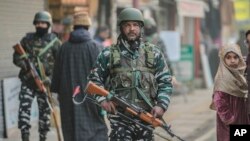 Indian paramilitary soldiers patrol a market in Srinagar, Indian-controlled Kashmir, Dec 23, 2023. Anger spread in some remote parts of Indian-controlled Kashmir after three civilians were killed while in army custody, officials and residents said. 