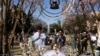 A man and a woman pray after laying flowers in front of a memorial marking the 12th anniversary of the massive earthquake, tsunami and nuclear disaster, at Hibiya Park in Tokyo, March 11, 2023.