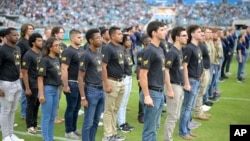 In this file photo, military recruits are sworn in during an NFL football game between the Jacksonville Jaguars and the Las Vegas Raiders, Nov. 6, 2022, in Jacksonville, Fla. (AP Photo/Phelan M. Ebenhack, File)