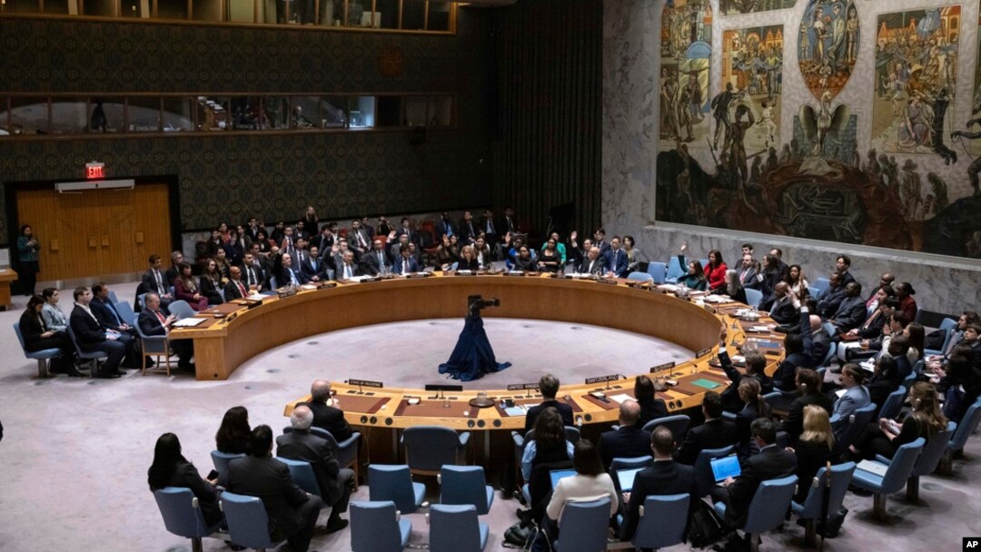 Representatives of member countries take votes during a Security Council meeting at United Nations headquarters, April 18, 2024. 