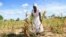 A villager shows maize crops wilting in a field, in Mumijo, Buhera district, east of the capital Harare, Zimbabwe, March 16, 2024. 