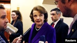 FILE — U.S. Senator Dianne Feinstein talks to reporters as she walks to the Senate floor on Capitol Hill in Washington, Dec. 9, 2014. Feinstein died Thursday at age 90.
