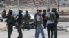 Members of Israeli security forces block a road leading to the site of a reported attack south of Hebron in the occupied West Bank, Aug. 21, 2023. 