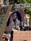 Students hold up a photo of University of Southern California 2024 valedictorian Asna Tabassum in protest to her canceled commencement speech on the campus of University of Southern California, in Los Angeles, April 18, 2024. 