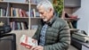 Peruvian journalist Gustavo Gorriti holds his book "Sendero" in Lima, Peru, June 28, 2024.