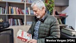 Peruvian journalist Gustavo Gorriti holds his book "Sendero" in Lima, Peru, June 28, 2024.