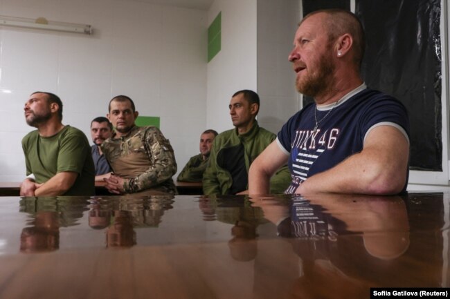 Service member with the call sign 'DJ' (blue shirt) attends a stress control class with his fellow soldiers at a military medical center in Donetsk region, Ukraine, November 17, 2023. (REUTERS/Sofiia Gatilova)