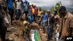 Relatives lay to rest two members of the Haringo family at a cemetery close to the scene of a landslide in Kencho Shacha Gozdi on July 26, 2024. 