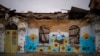 A painting decorates the façade of a house damaged during the Russian occupation in Bucha, near Kyiv, Ukraine, Feb. 17, 2023.