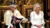 Raja Charles III menunggu untuk membacakan Pidato Raja Inggris, sementara Ratu Camilla duduk di sebelahnya selama Pembukaan Parlemen Inggris di House of Lords, London. Pidato Charles akan memaparkan agenda pemerintahan Partai Buruh pertama di Inggris selama 14 tahun. (AP)&nbsp;