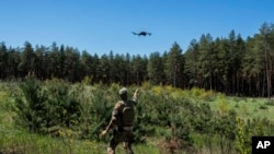 A Ukrainian Border Guard soldier prepares to catch a drone during a military exercise in central Ukraine, May 2, 2023.