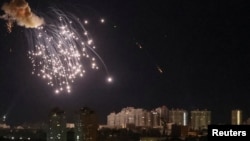An explosion of a drone is seen in the sky over the city during a Russian drone strike in Kyiv, Ukraine, Sept. 10, 2023. 