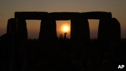 FILE - People gather at Stonehenge to celebrate the Summer Solstice, the longest day of the year, near Salisbury, England, June 21, 2023. (AP Photo/Kin Cheung)