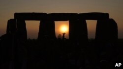 People gather at Stonehenge to celebrate the Summer Solstice, the longest day of the year, near Salisbury, England, June 21, 2023. (AP Photo/Kin Cheung)