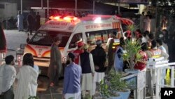 Rescue workers unload earthquake victims from an ambulance at a hospital in Saidu Sharif, a town in Pakistan's Swat Valley, March 21, 2023.