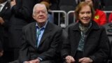 FILE - Former President Jimmy Carter, left, and his wife, Rosalynn, attend an NBA game between the Atlanta Hawks and the New York Knicks at State Farm Arena in Atlanta on Feb. 14, 2019. (Dale Zanine-USA Today Sports via Reuters)