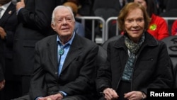 FILE - Former President Jimmy Carter, left, and his wife, Rosalynn, attend an NBA game between the Atlanta Hawks and the New York Knicks at State Farm Arena in Atlanta on Feb. 14, 2019. (Dale Zanine-USA Today Sports via Reuters)
