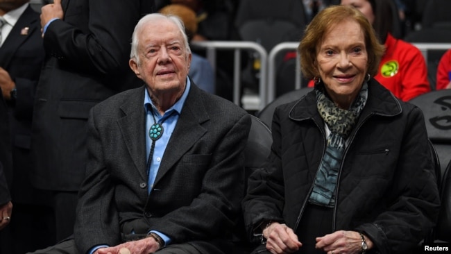 FILE - Former President Jimmy Carter, left, and his wife, Rosalynn, attend an NBA game between the Atlanta Hawks and the New York Knicks at State Farm Arena in Atlanta on Feb. 14, 2019. (Dale Zanine-USA Today Sports via Reuters)