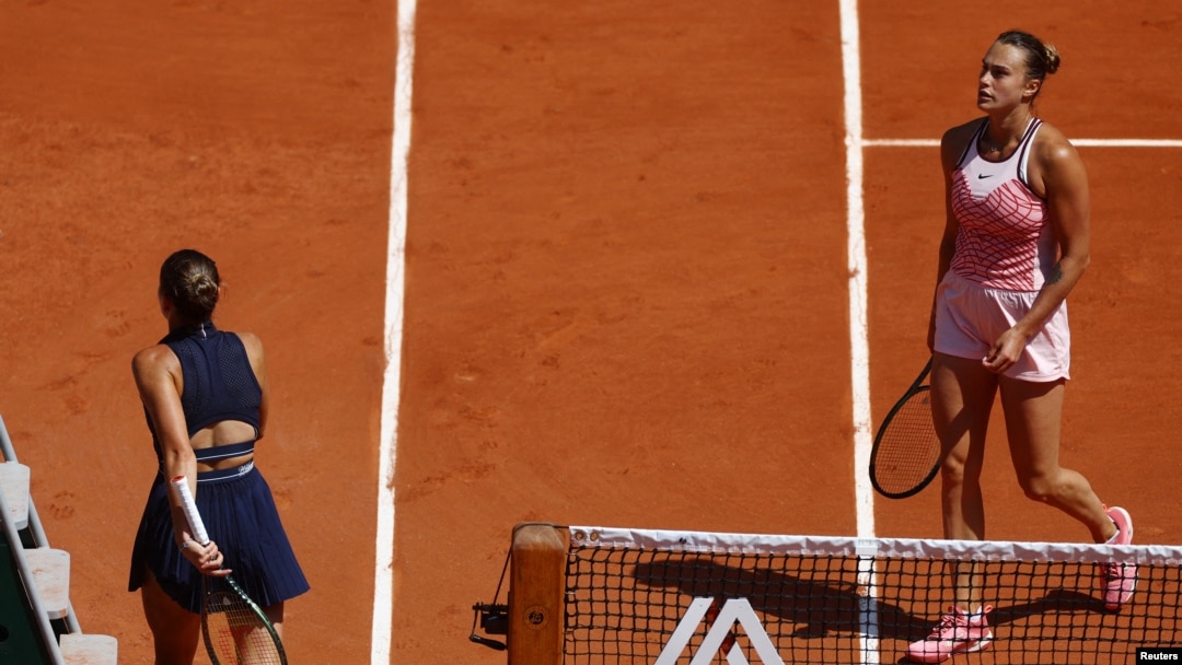 Ukraine's Marta Kostyuk, left, walks past Belarus' Aryna Sabalenka after losing her first round match at the French Open in Paris, France, May 28, 2023.