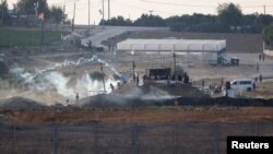 Israeli soldiers and Palestinian protesters clash near the border between Israel and the Gaza Strip as seen from the Israeli side, Sept. 23, 2023.