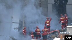 Firefighters work on the rubble at 'rue Tivoli' after a building collapsed in the street, in Marseille, southern France, Apr. 9, 2023.