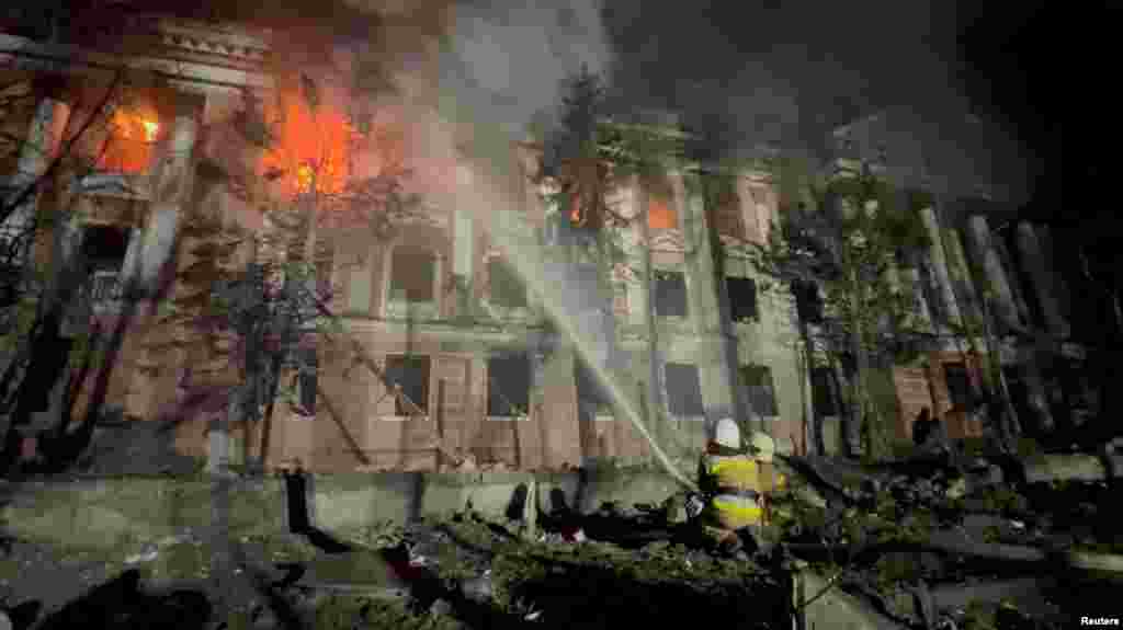 Firefighters work at a site of a building damaged by a Russian missile strike in Mykolaiv, Ukraine, in this screengrab taken from a handout video by&nbsp;State Emergency Service of Ukraine.