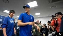 FILE - Los Angeles Dodgers star Shohei Ohtani, right, and his interpreter, Ippei Mizuhara, leave after a news conference at Gocheok Sky Dome in Seoul, South Korea, March 16, 2024. Ohtani's interpreter has been fired over allegations of illegal gambling. 