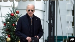 US President Joe Biden walks towards the members of the media as he leaves the White House to spend the Christmas holiday with his family at Camp David presidential retreat, near Thurmont, Md., Dec. 23, 2023.