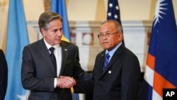 FILE - Secretary of State Antony Blinken greets Marshall Islands President David Kabua in Washington, Sept. 29, 2022. In 2023, the U.S. has signed memorandums of understanding on renewals of Compacts of Free Association with the Marshalls, Palau and Micronesia.