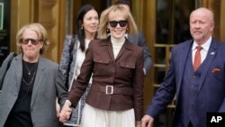 E. Jean Carroll, center, walks out of Manhattan federal court in New York, May 9, 2023. A jury found Donald Trump liable for sexually abusing the advice columnist in 1996, awarding her $5 million.