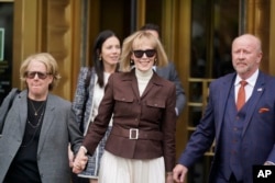 FILE - E. Jean Carroll, center, walks out of Manhattan federal court in New York, May 9, 2023.