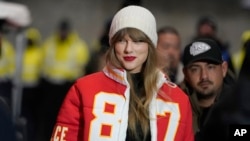 FILE - Taylor Swift wears a Kansas City Chiefs tight end Travis Kelce jacket as she arrives before an NFL wild-card playoff football game between the Chiefs and the Miami Dolphins, Jan. 13, 2024, in Kansas City, Missouri.