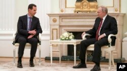 Russian President Vladimir Putin, right, listens to Syrian President Bashar al-Assad during their meeting at the Kremlin in Moscow, Russia, March 15, 2023.