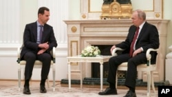 FILE - Russian President Vladimir Putin, right, listens to Syrian President Bashar al-Assad during their meeting at the Kremlin in Moscow, Russia, March 15, 2023.