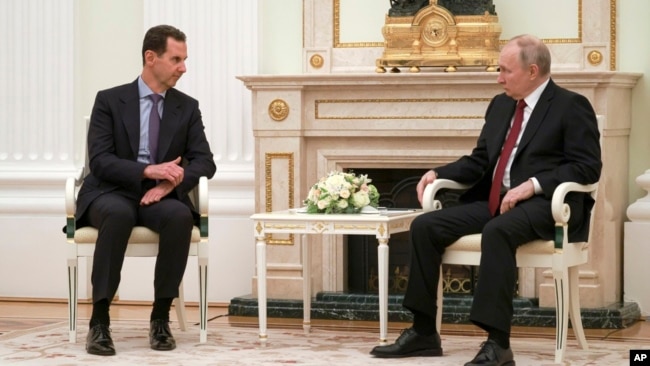 FILE - Russian President Vladimir Putin, right, listens to Syrian President Bashar al-Assad during their meeting at the Kremlin in Moscow, Russia, March 15, 2023.