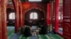 FILE - Muslim men read the Quran while waiting for the time to break their fast during the first day of Ramadan at the Niujie Mosque in Beijing, March 12, 2024. 