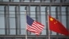 Chinese and U.S. flags flutter outside the building of an American company in Beijing, China, January 21, 2021.