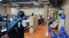 FILE - In this photo provided by the Philippine National Police Anti-Cybercrime Group, police raid an office in Las Pinas, Philippines, on June 27, 2023. The UN says criminal gangs have forced hundreds of thousands of people in Asia into participating in online scam operations.