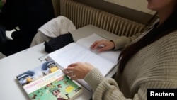 A textbook is seen on a high school student's desk during a philosophy class at the Averroes school, France's biggest Muslim educational institution that has lost its state funding, Lille, France, March 19, 2024.